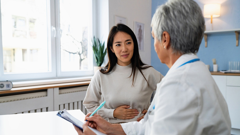 A woman speaking to a doctor during an checkup