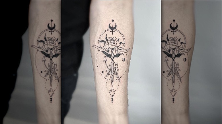 arm with abstract geometric fine line tattoo