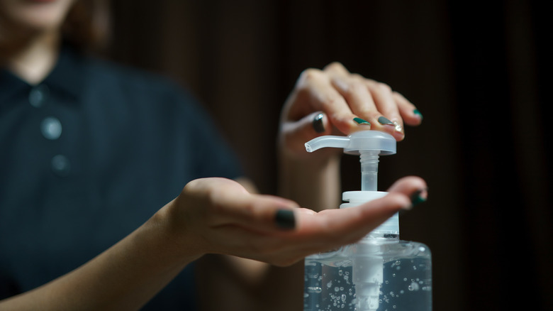 Woman using hand sanitizer