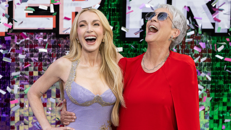 Lindsay Lohan in a lavender gown and Jamie Lee Curtis smiling in a red gown at 