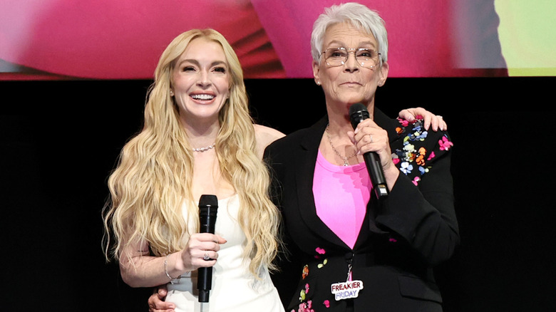 Lindsay Lohan and Jamie Lee Curtis smiling together on stage.