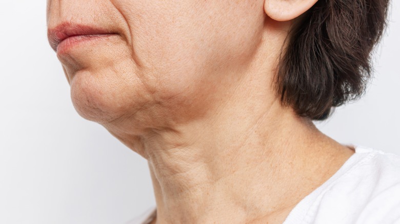 Model examining skin on face