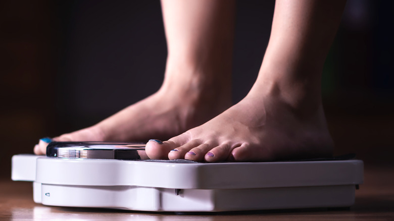 Model standing on scale