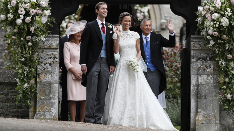 Pippa Middleton and James Matthews standing behind Carole and Michael Middleton