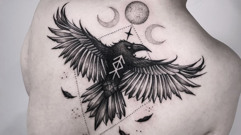 person with crow back tattoo