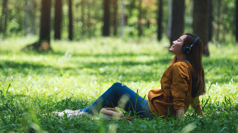 Asian woman relaxing in forest