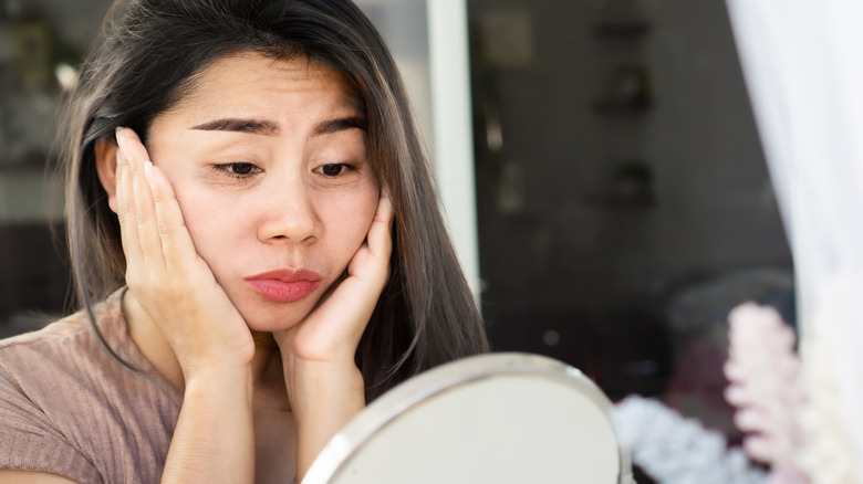 person looking at their eye bags