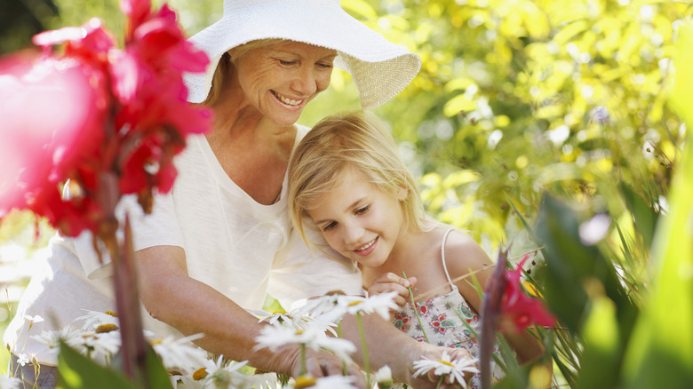 child and older woman gardening