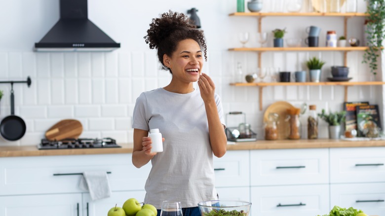 Woman taking a supplement