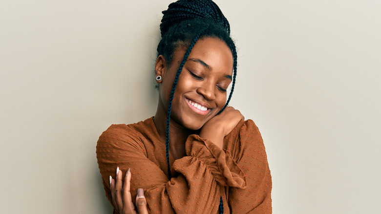 woman hugging herself