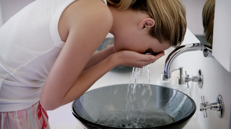 Woman washing her face