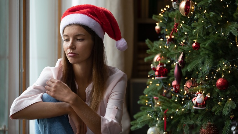 sad woman next to tree