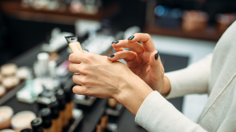 person testing makeup on the back of her hand