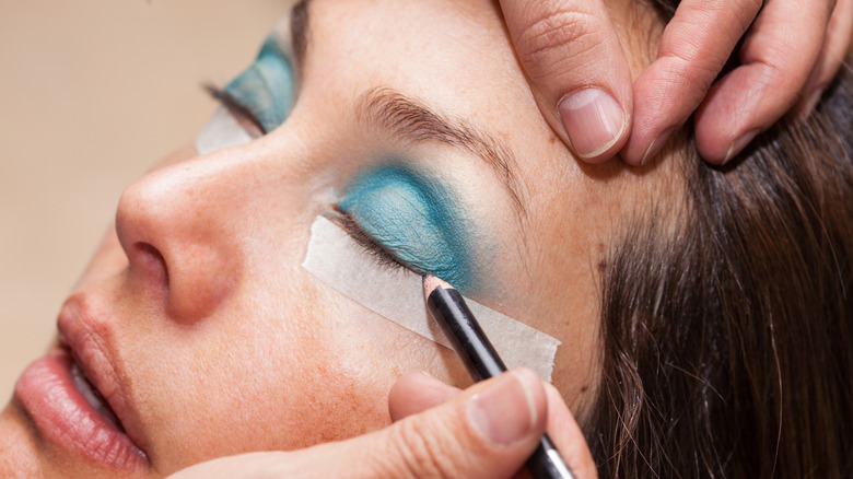 makeup artist using tape