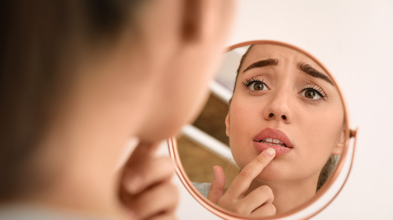 panicked woman touching lip