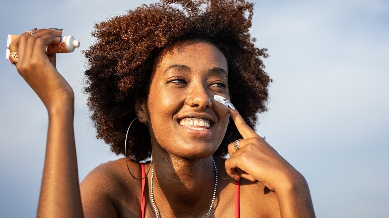 Woman applying sunscreen