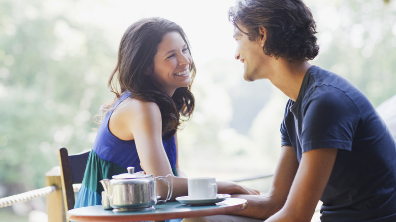Two people sitting at table outside