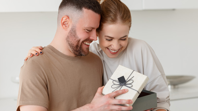 couple opening gift together