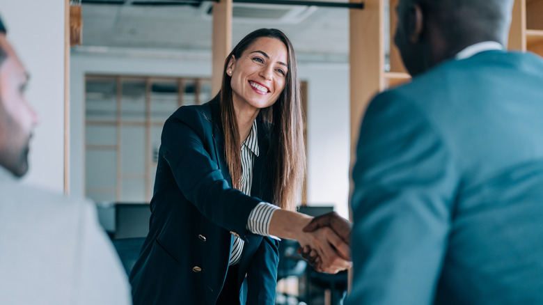 woman shaking hands in meeting