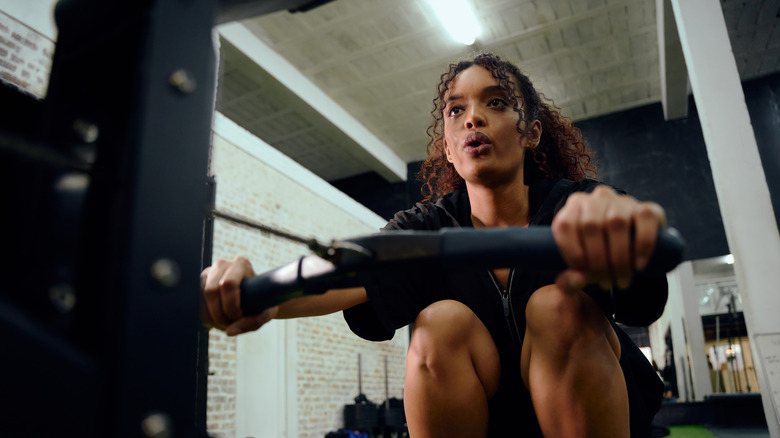 Black female using rowing machine