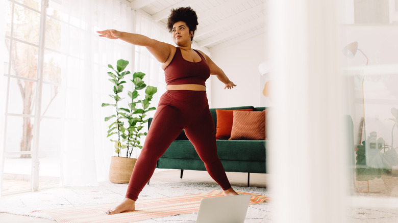 woman doing yoga in living room