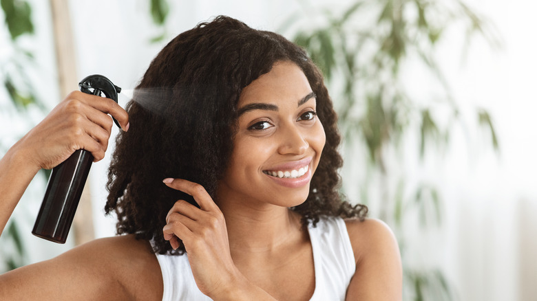 woman applying hair product
