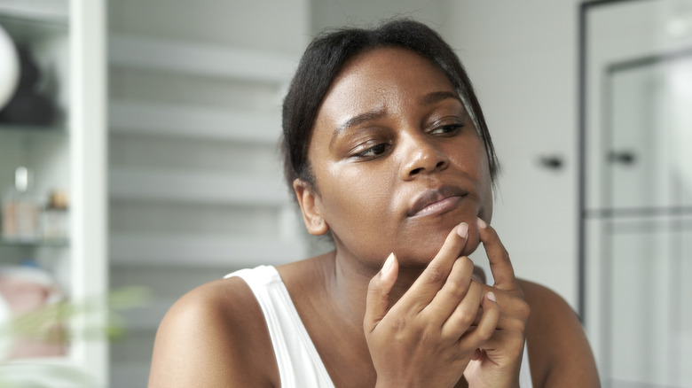 woman popping pimple