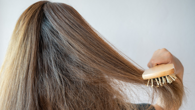 woman brushing messy hair