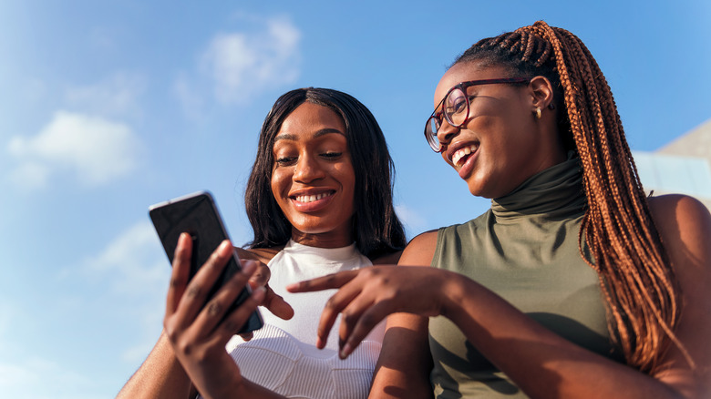 Women smiling at phone