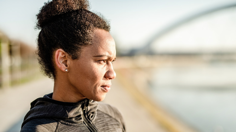 Woman outdoors with tense look