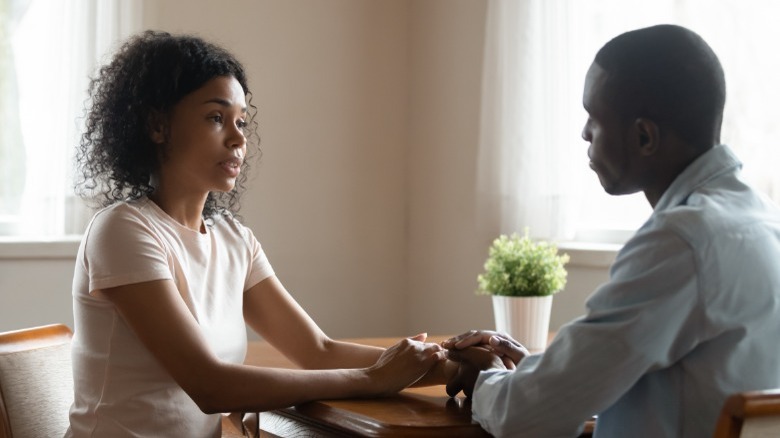 Black couple sitting at table