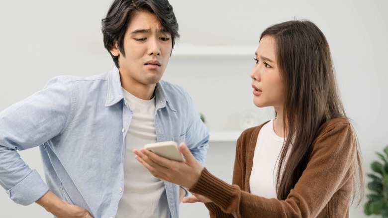 Asian couple looking at phone
