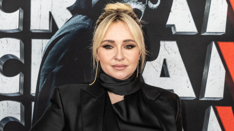 Hayden Panettiere posing on the red carpet wearing a black satin blazer
