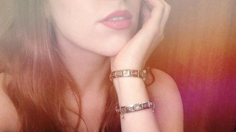 Faceless woman models nomination bracelets 