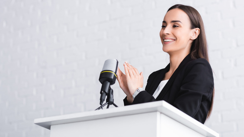 female politician smiling at podium