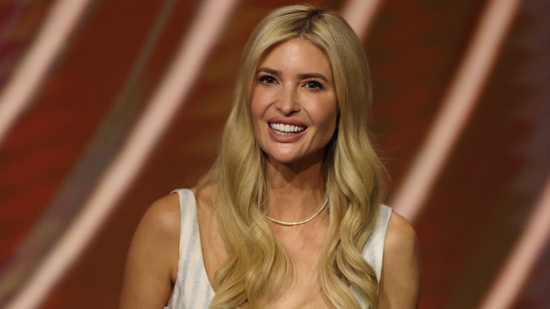 Ivanka Trump with her blond hair in waves and her dark roots growing