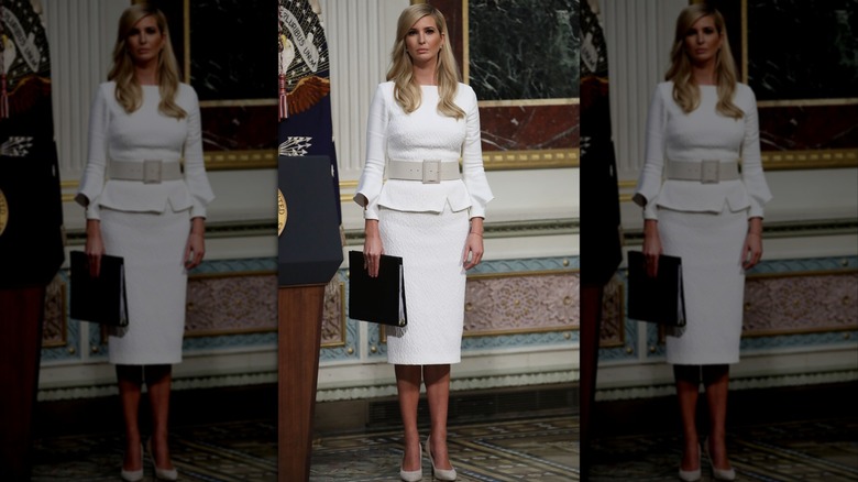 Ivanka Trump wearing a white outfit with a statement belt.