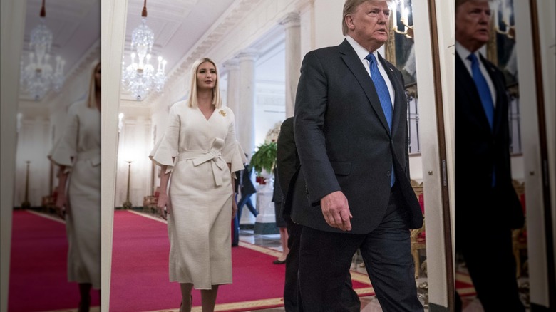Ivanka Trump wearing a white dress that ties in the front.