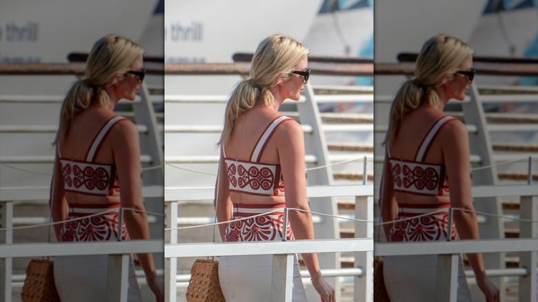 Ivanka Trump walking on a Venetian boat in a two-piece patterned set