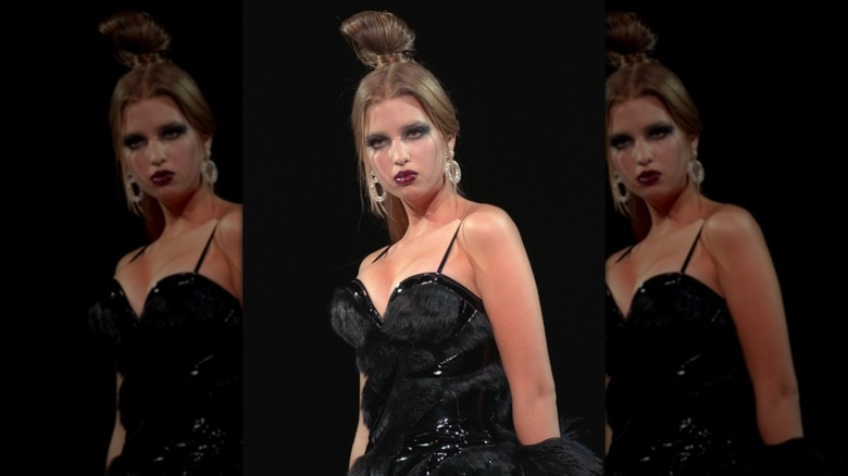 Ivanka Trump wearing a black leather-fur outfit with a top knot