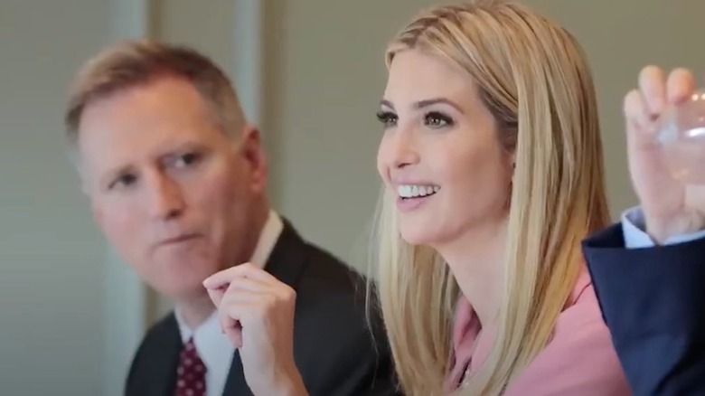 Ivanka Trump wearing a pink outfit while talking in a meeting