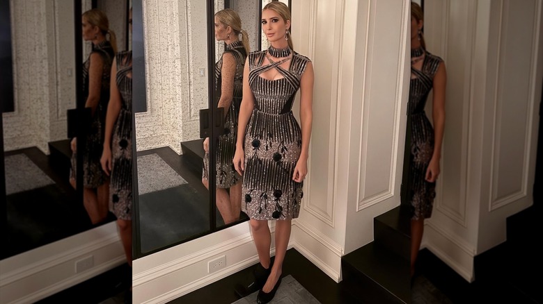Ivanka Trump is a metallic midi dress with her hair in a ponytail