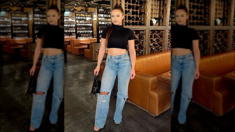 Woman wearing ripped jeans, heels