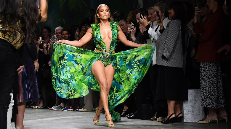 Jennifer Lopez walking in her iconic green Versace dress at Milan Fashion Week