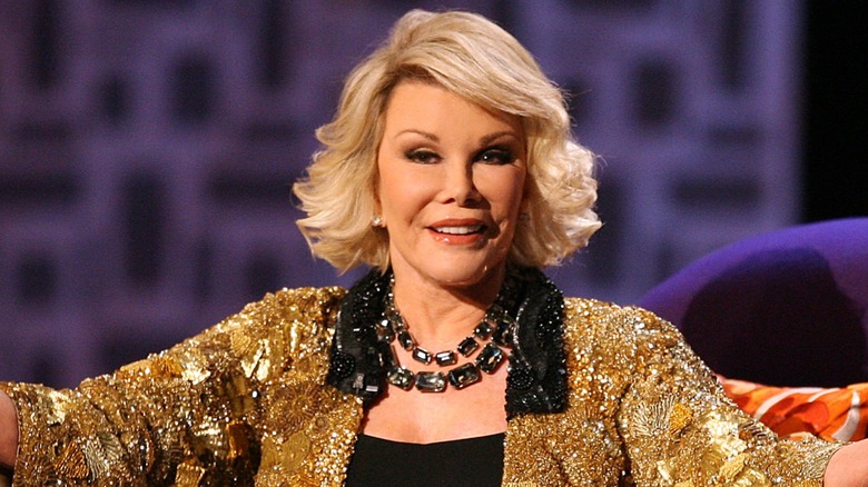 Joan Rivers posing with her arms out