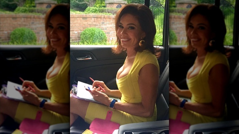 Jeanine Pirro sits in the back of a car doing work