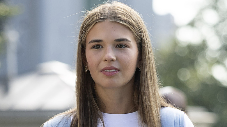 Kai Trump in a white shirt