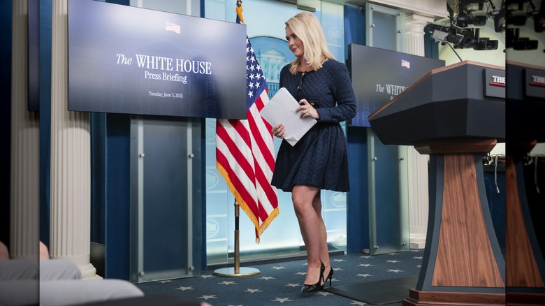 Karoline Leavitt walking away from a press briefing