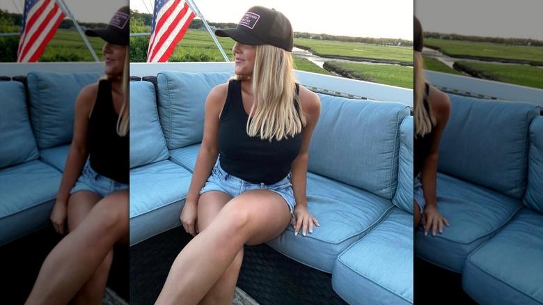 Karoline Leavitt wearing denim short-shorts and a tank top