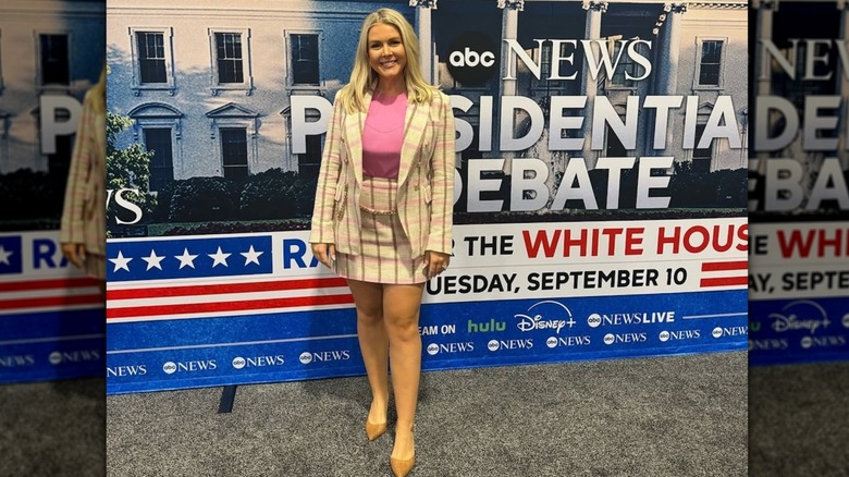 Karoline Leavitt posing in a plaid skirt suit